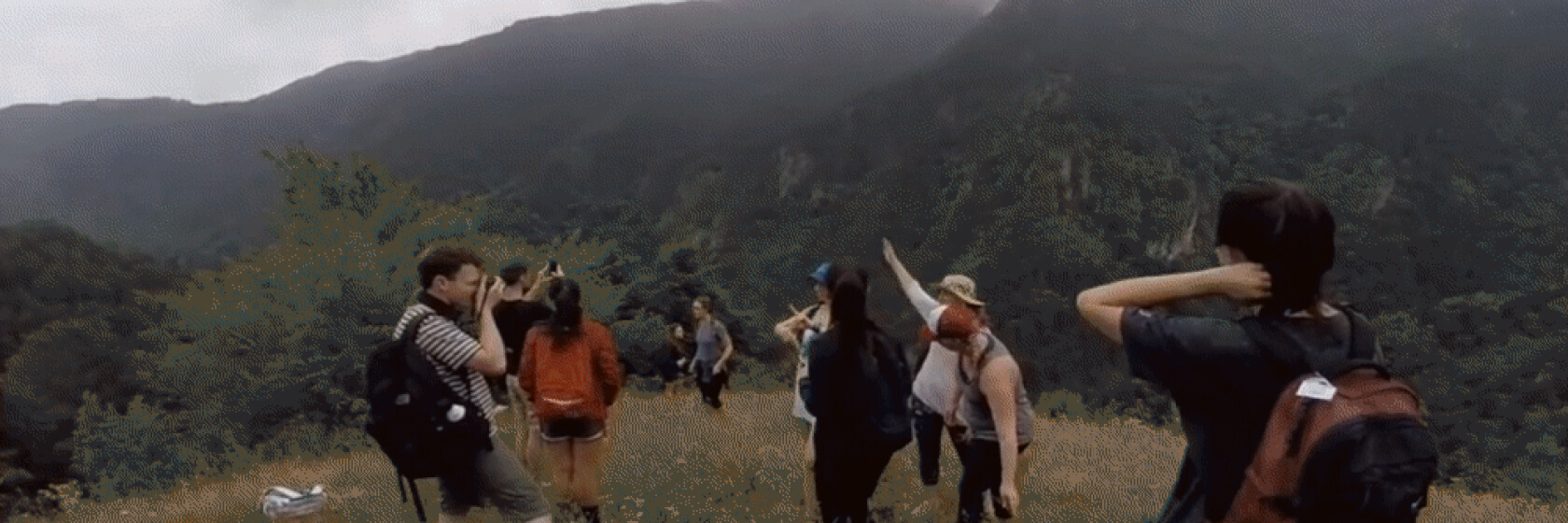 Student group hikes through valley.