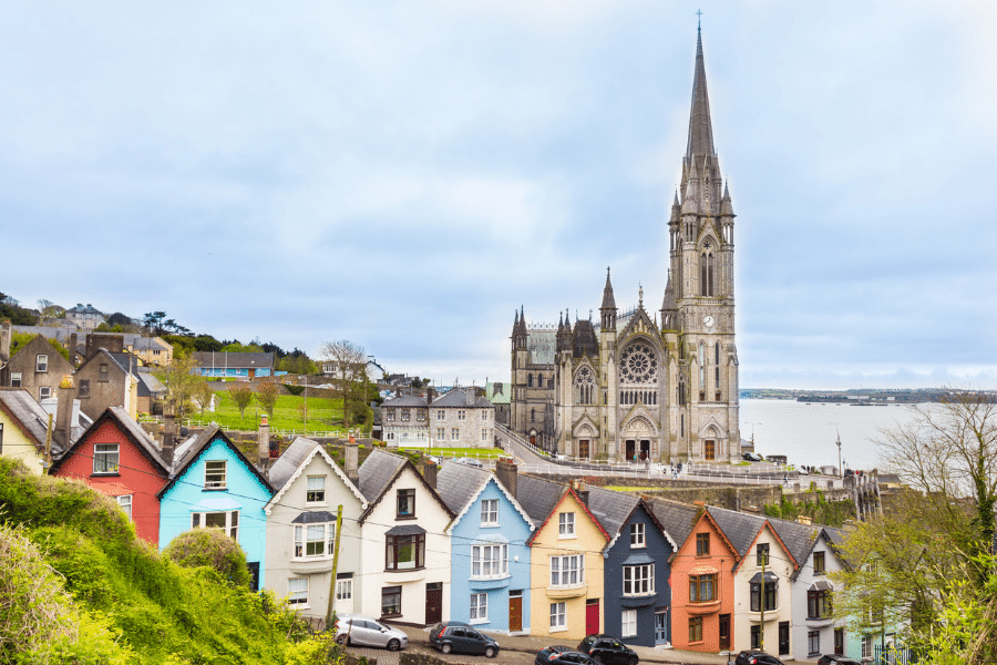 Church in Cork, Ireland behind a colorful row of houses.