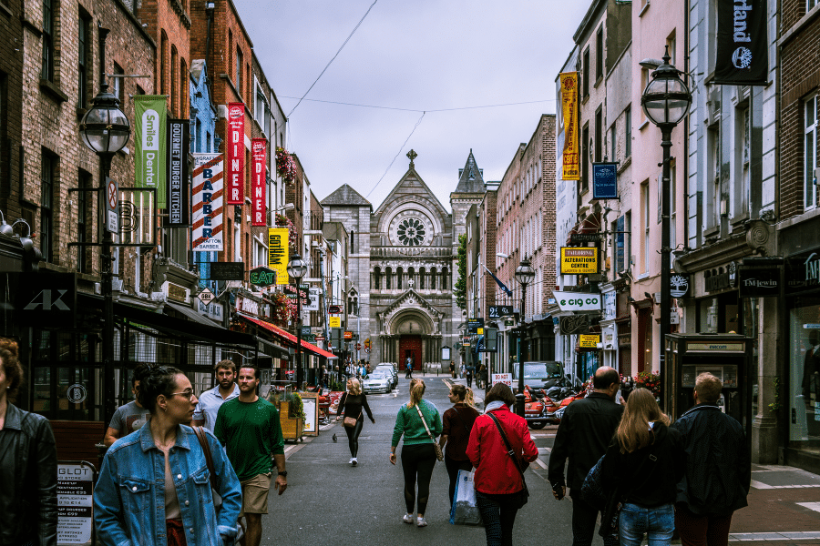 People stroll through a shopping street that's located in Ireland.