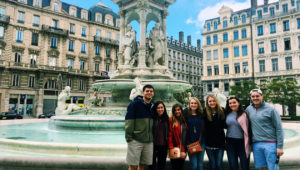 Group stands near fountain in Paris.