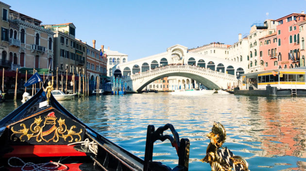 Gondola approaching Rialto Bridge in Venice.