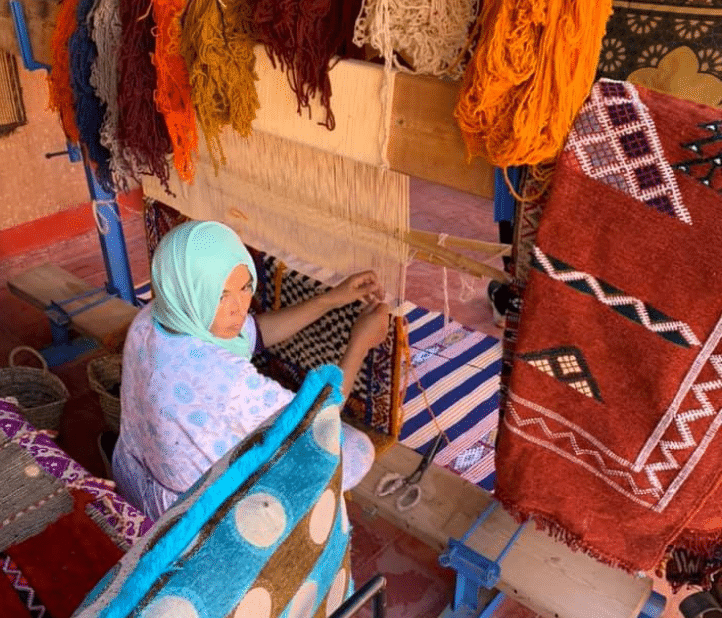 Traditional carpets being woven by hand in Morocco.